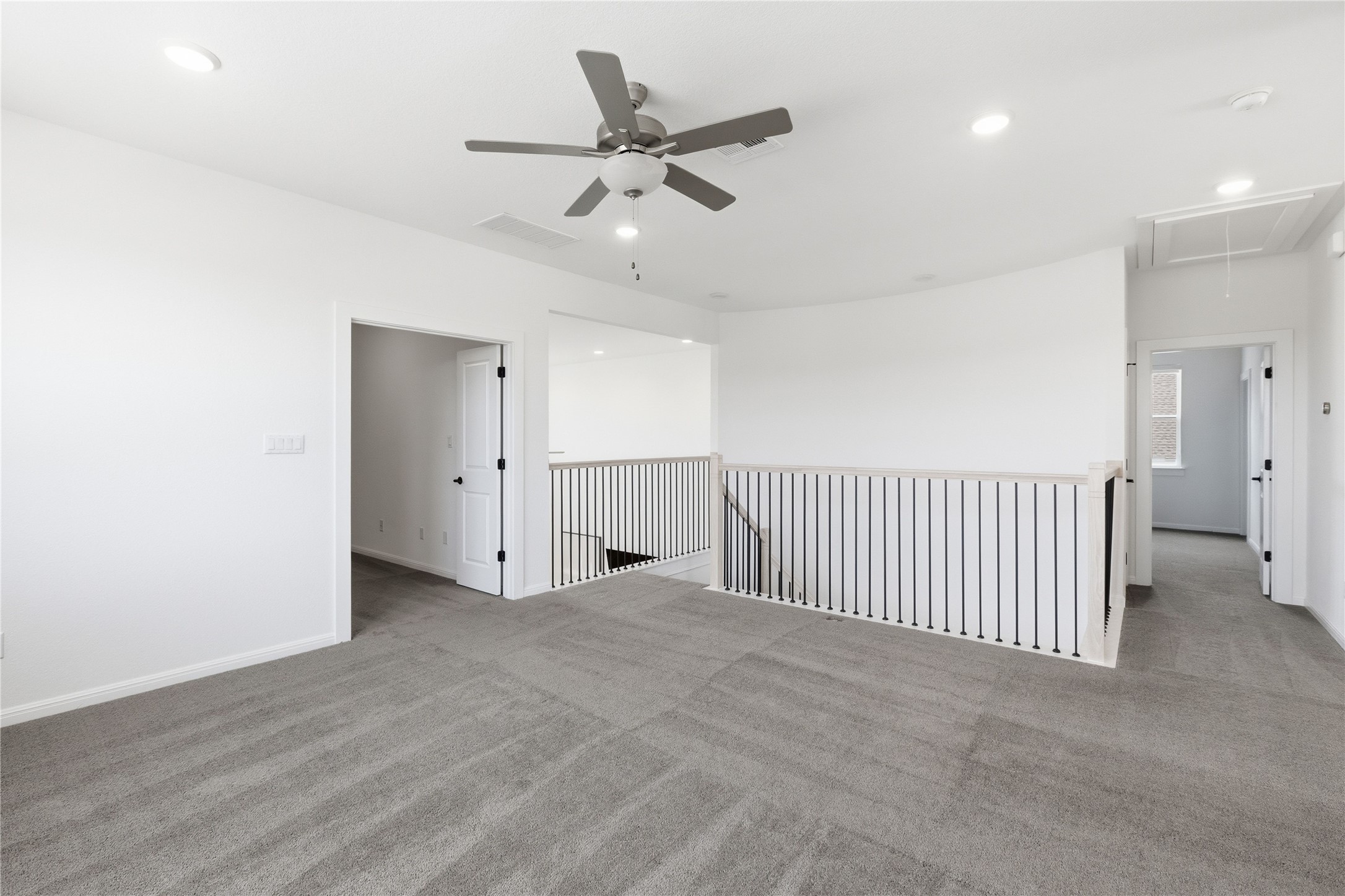 836 Villa Rialto View Leander, TX 78641 - Photo 25 of 33 An open and versatile loft space provides additional living area, complemented by recessed lighting and a ceiling fan.