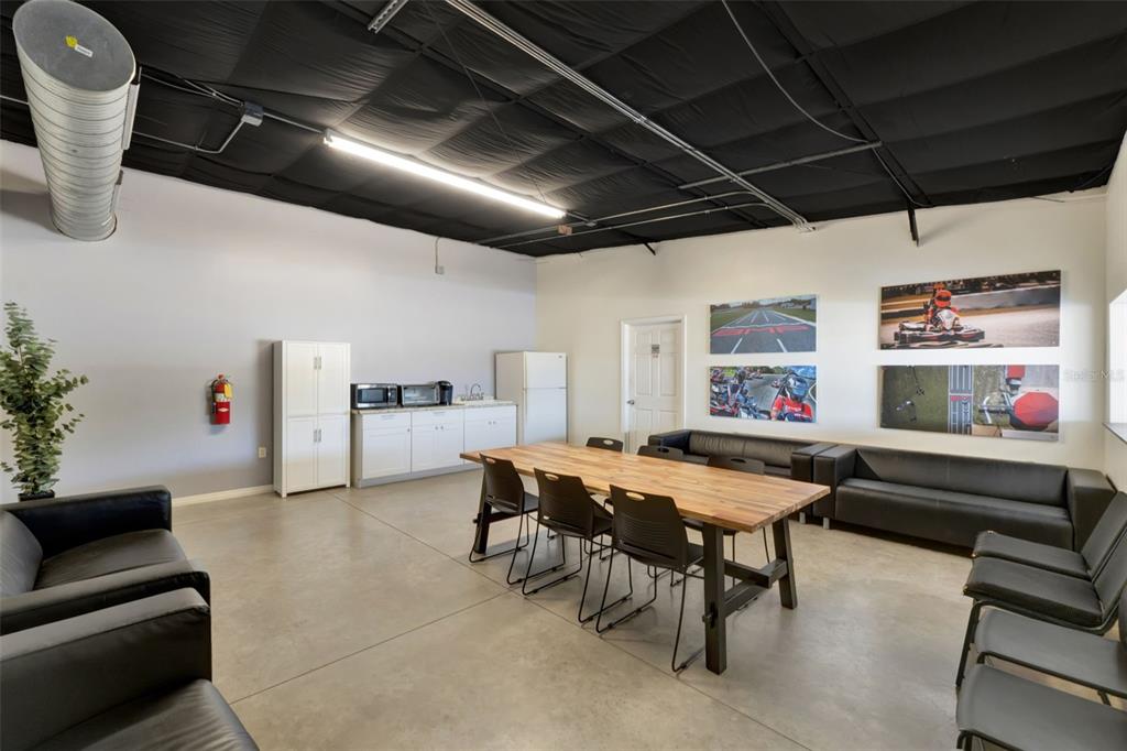 5765 Pit Road Bushnell, FL 33513 - Photo 13 of 35 a dining room with furniture and a chandelier