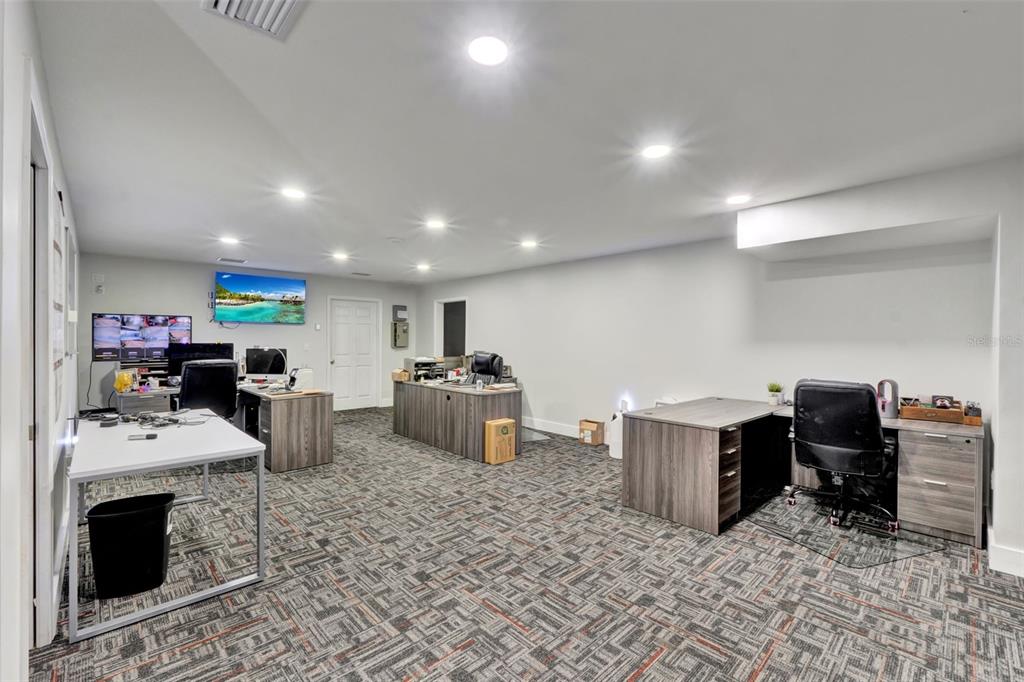 5765 Pit Road Bushnell, FL 33513 - Photo 17 of 35 a room with furniture a flat screen tv and a table