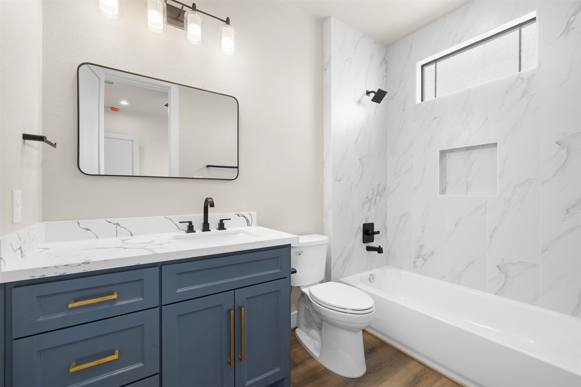 114 Country View Lane Road Schulenburg, TX 78956 - Photo 17 of 27 a bathroom with a toilet a sink a tub and mirror