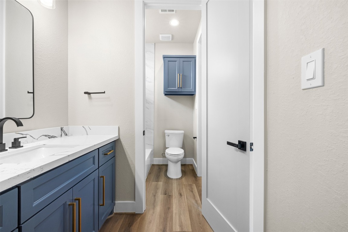 114 Country View Lane Road Schulenburg, TX 78956 - Photo 19 of 27 a bathroom with a granite countertop toilet a sink and a mirror