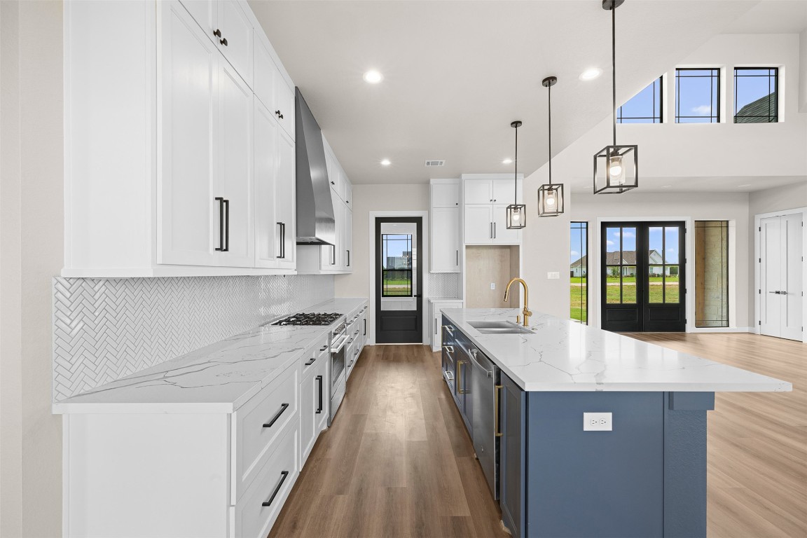 114 Country View Lane Road Schulenburg, TX 78956 - Photo 7 of 27 a kitchen with stainless steel appliances granite countertop a lot of counter space and wooden floors