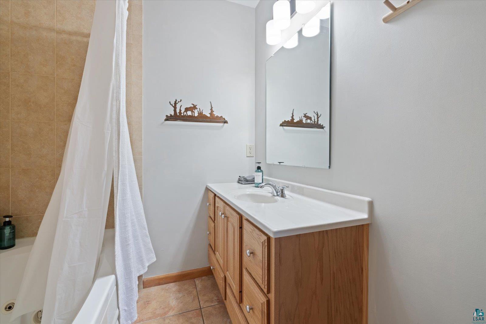 6266 Giants Ridge Road Biwabik, MN 55705 - Photo 32 of 37 Single vanity with a light wood-finish cabinet and integrated sink