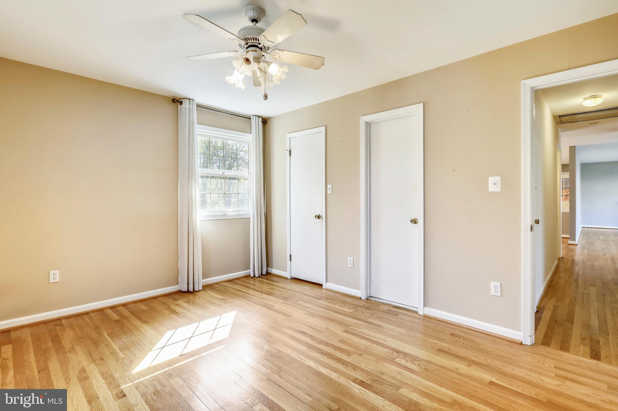 3728 Briars Road Olney, MD 20832 - Photo 25 of 54 a view of a bedroom with wooden floor and a ceiling fan