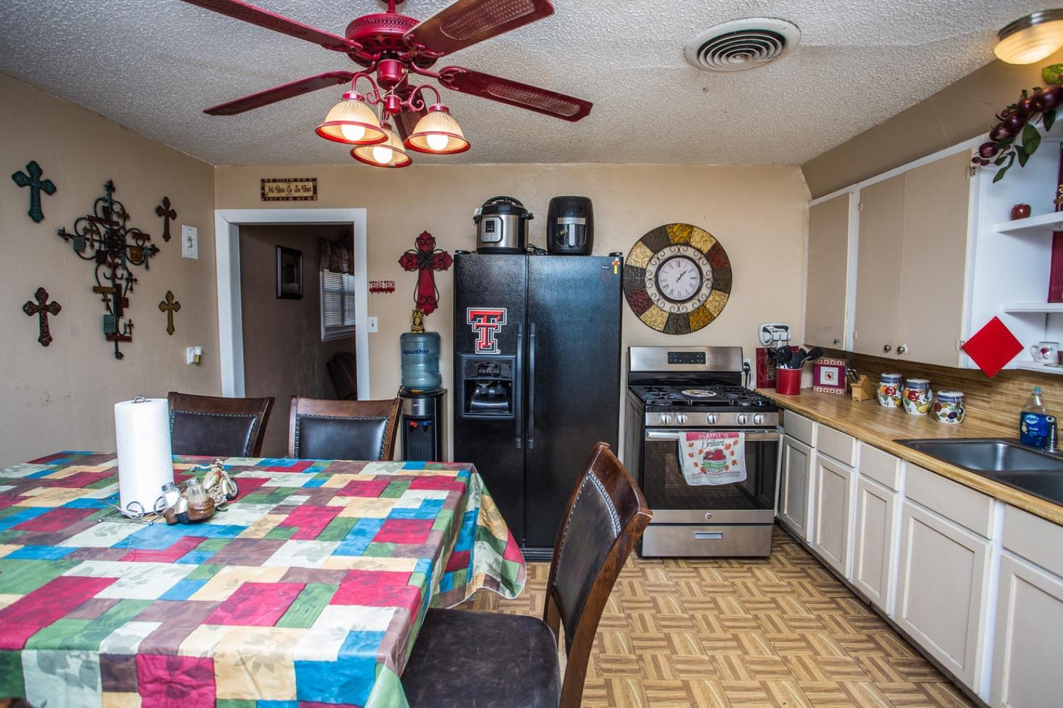 306 Terry Avenue Wellman, TX 79316 - Photo 11 of 32 a kitchen with stainless steel appliances granite countertop a dining table and chairs