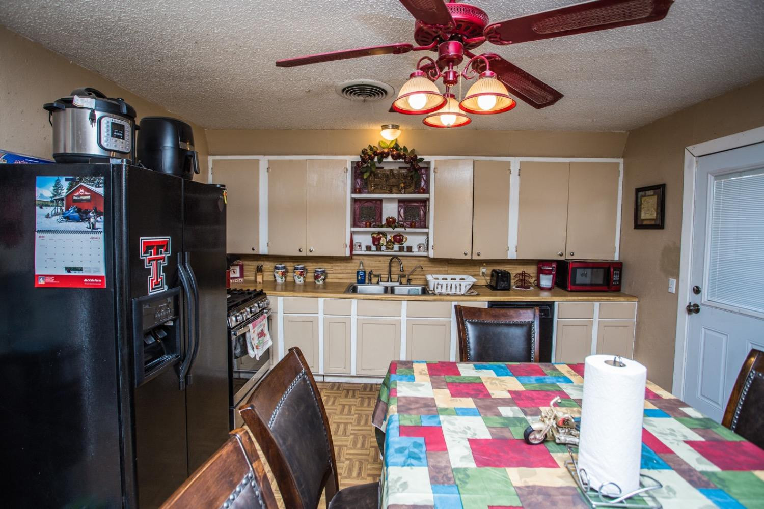 306 Terry Avenue Wellman, TX 79316 - Photo 12 of 32 a kitchen that has a lot of cabinets in it