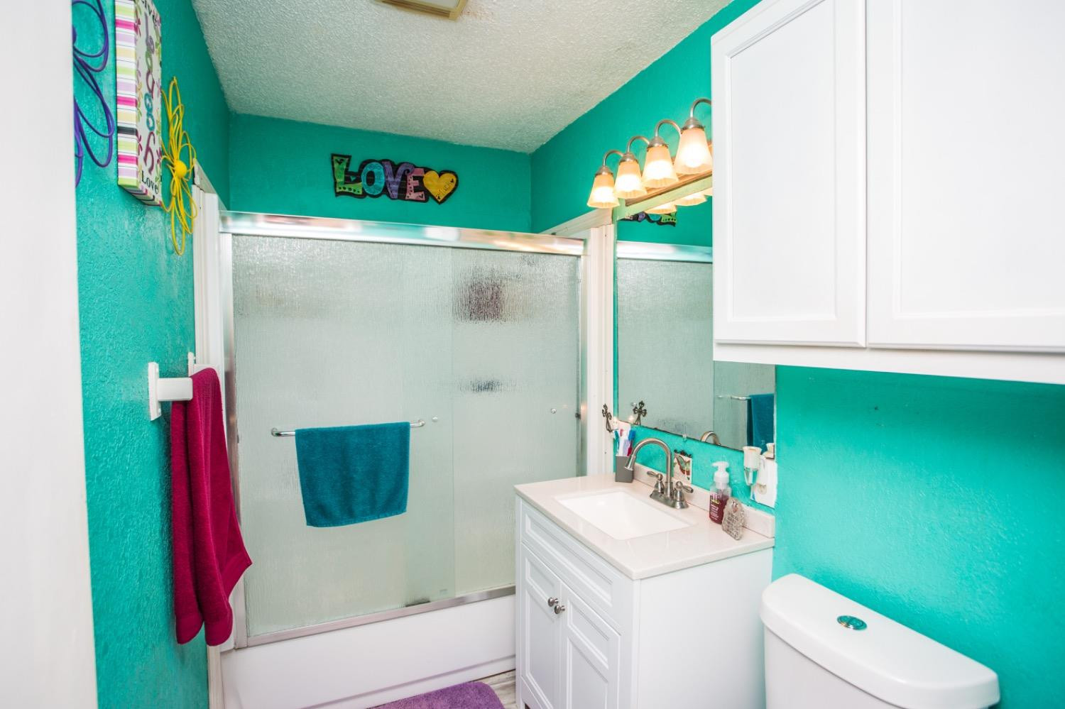 306 Terry Avenue Wellman, TX 79316 - Photo 16 of 32 a bathroom with a sink toilet and a mirror