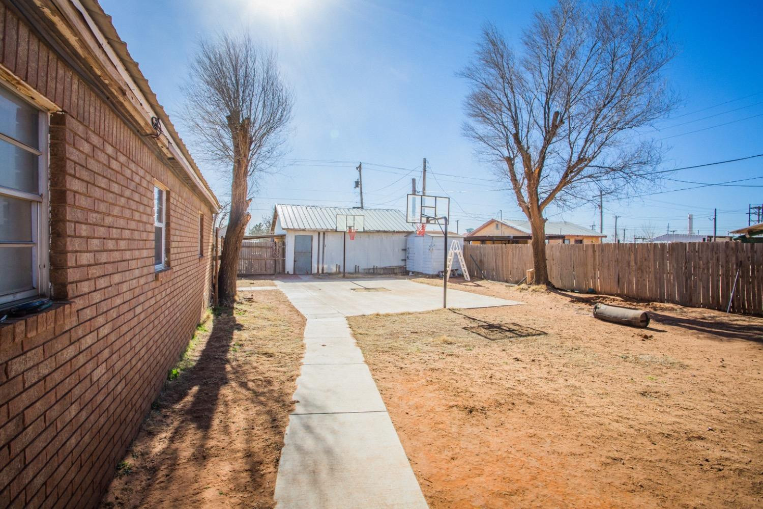 306 Terry Avenue Wellman, TX 79316 - Photo 27 of 32 a house with trees in the background
