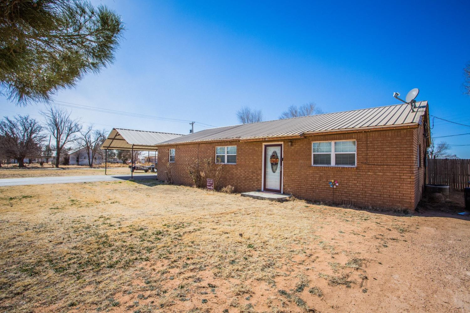 306 Terry Avenue Wellman, TX 79316 - Photo 3 of 32 a front view of a house with a yard