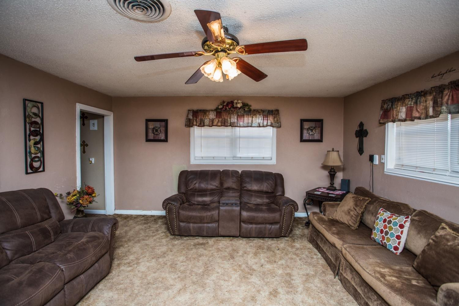 306 Terry Avenue Wellman, TX 79316 - Photo 6 of 32 a living room with furniture ceiling fan and a window