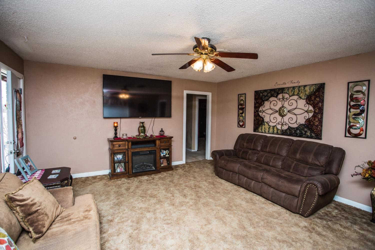 306 Terry Avenue Wellman, TX 79316 - Photo 7 of 32 a living room with furniture and a flat screen tv