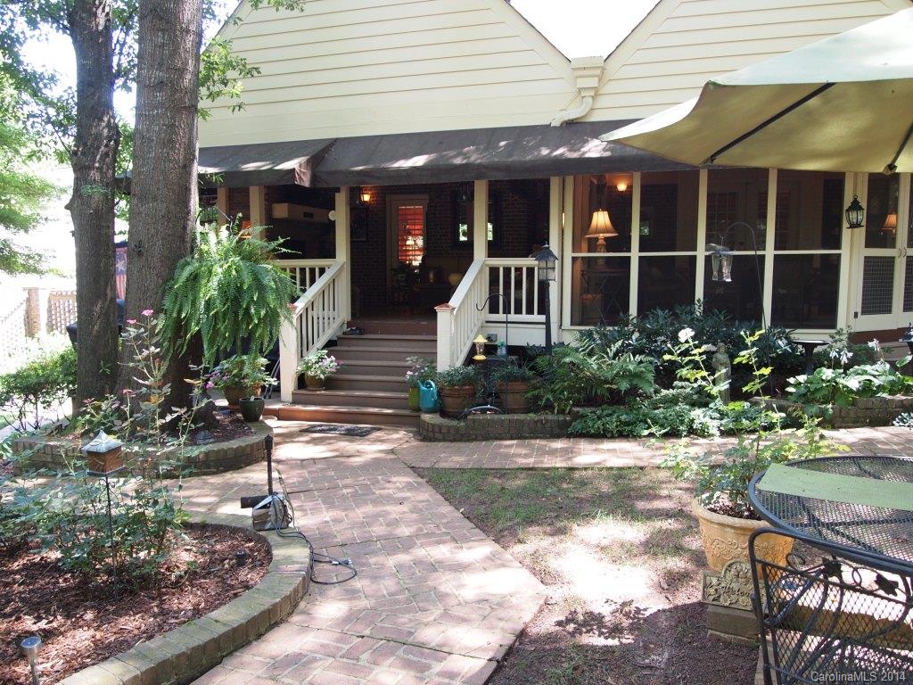 557 Cranborne Chase, Unit 16 Fort Mill, SC 29708 - Photo 22 of 23 a view of a house with potted plants and a bench