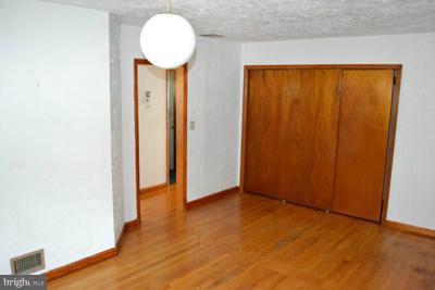 8106 Ridgely Oak Road Baltimore, MD 21234 - Photo 2 of 21 a view of a room with wooden floor and a chandelier