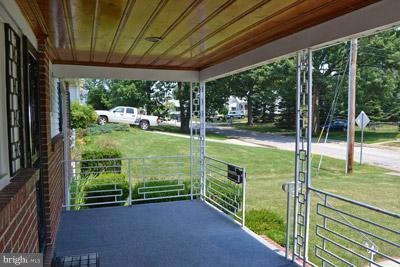 8106 Ridgely Oak Road Baltimore, MD 21234 - Photo 16 of 21 a view of a porch with furniture and garden