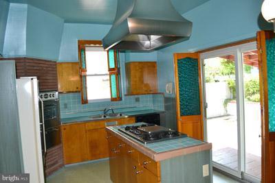8106 Ridgely Oak Road Baltimore, MD 21234 - Photo 3 of 21 a kitchen with stainless steel appliances granite countertop a stove a refrigerator and a wooden cabinets