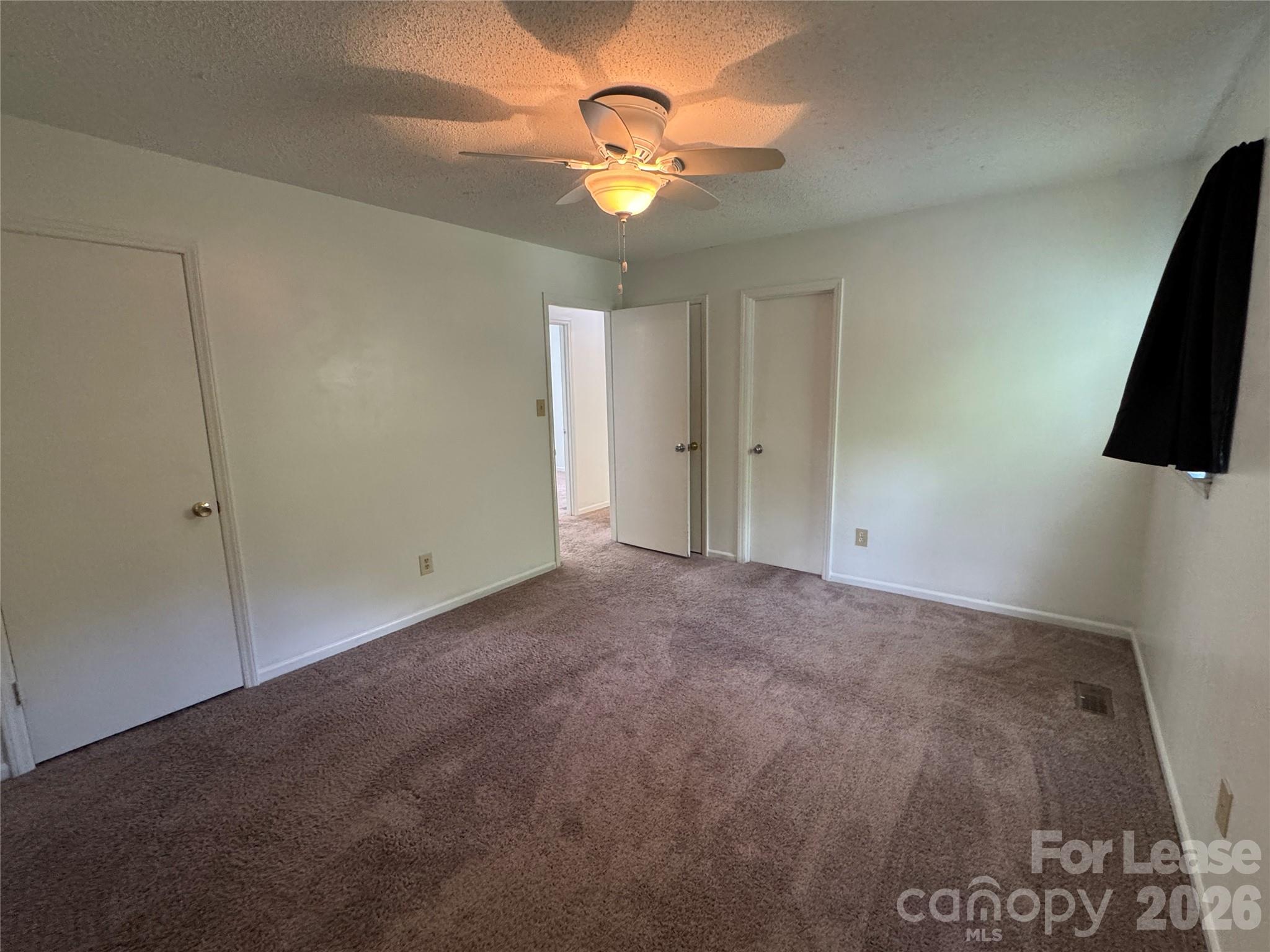 315 Pine Road Mount Holly, NC 28120 - Photo 8 of 21 a view of a room with a ceiling fan and a window