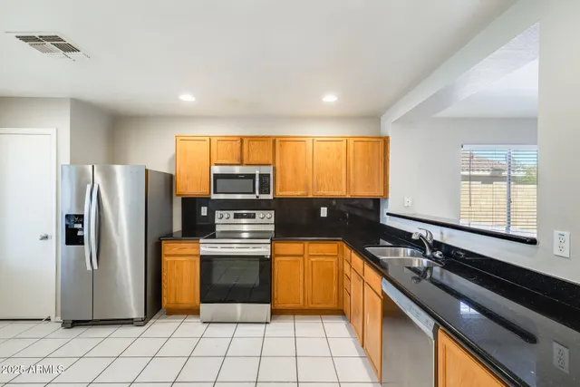 a view of a hallway with wooden floor and entryway