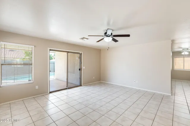 a view of a livingroom with an empty space and a window