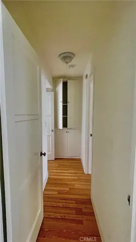 a view of a hallway with wooden floor and a hallway