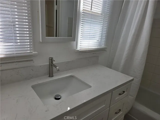 a bathroom with a sink and a window