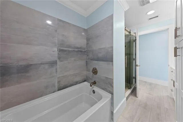 a bathroom with a bathtub and a shower