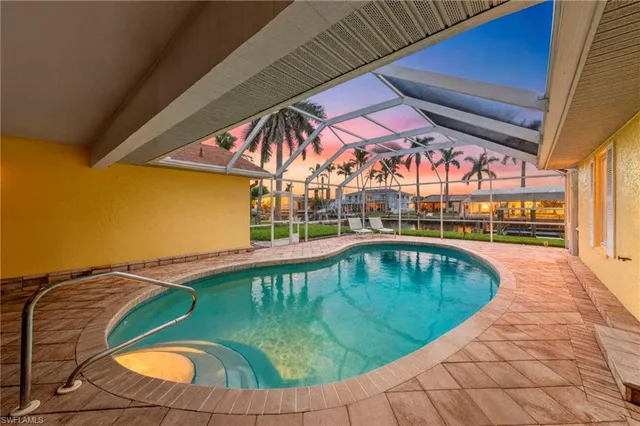 an outdoor space with swimming pool and furniture