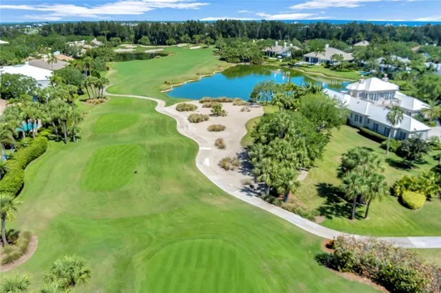 an aerial view of a house with a yard and lake view