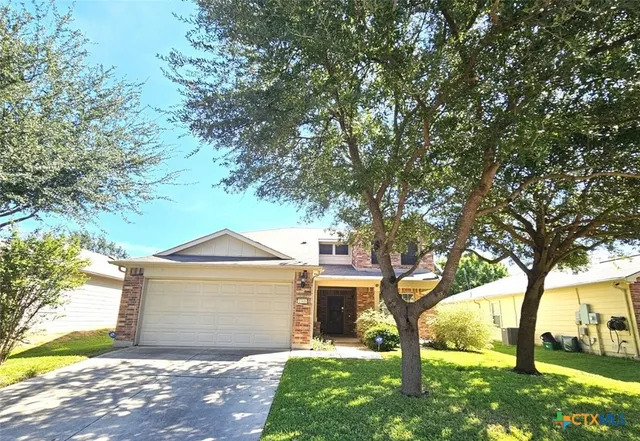 a front view of house with yard and green space