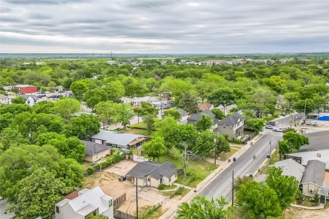 an aerial view of residential houses with outdoor space and street view