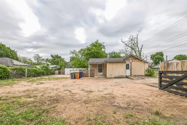 a backyard of a house with lots of green space and lake view