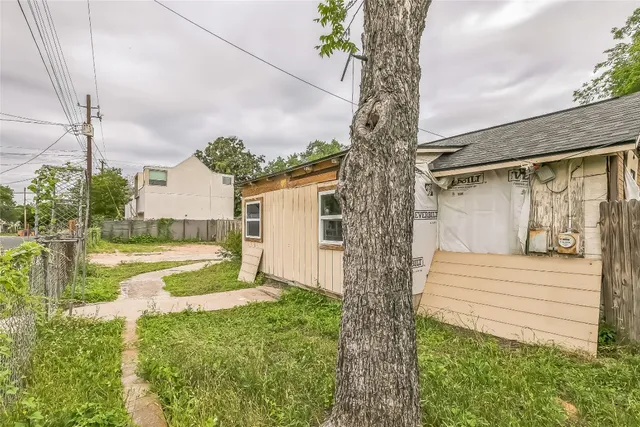 a view of a backyard with plants and lake view
