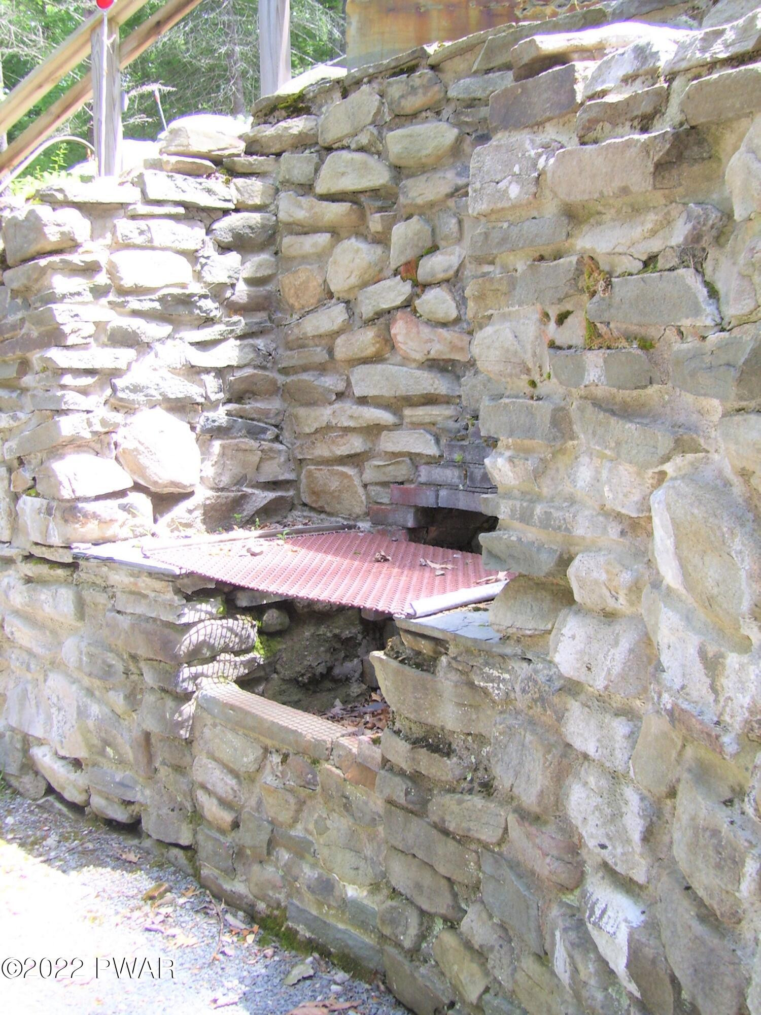 50 Paupack Point Road Hawley, PA 18428 - Photo 53 of 59 Stone Wall with built in BBQ