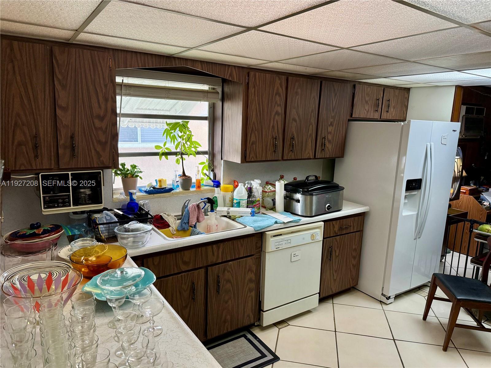 6341 Tamiami Canal Road Miami, FL 33126 - Photo 4 of 13 a kitchen with a refrigerator and a stove top open