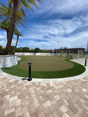 a view of a patio with couches and table and chairs with wooden fence