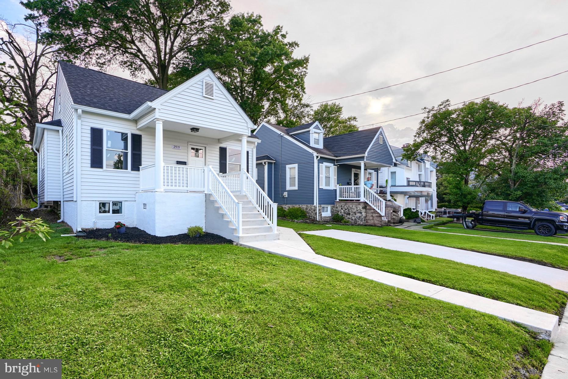a front view of house with yard and green space