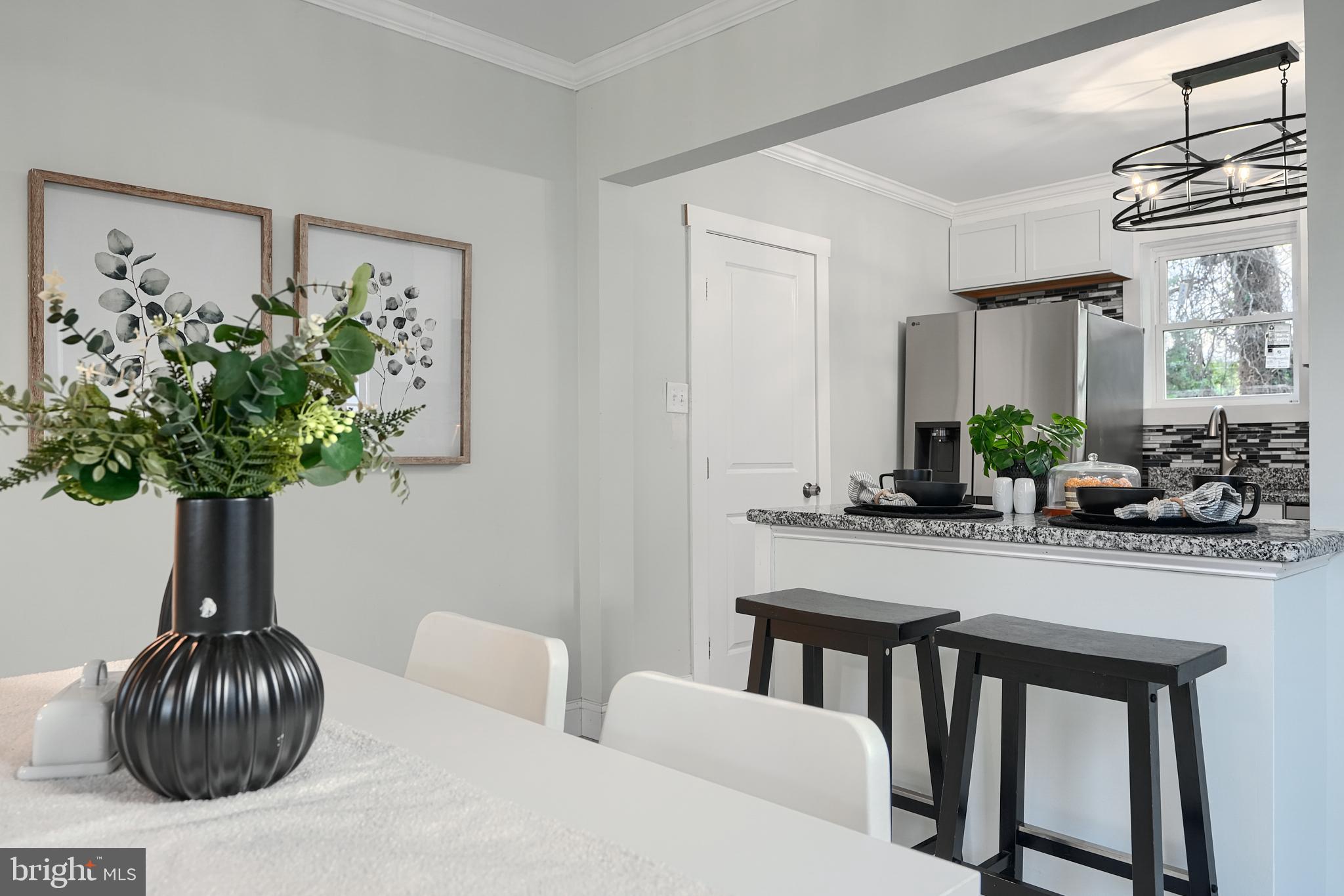 2919 Onyx Road Baltimore, MD 21234 - Photo 12 of 41 a living room with furniture a chandelier and a potted plant