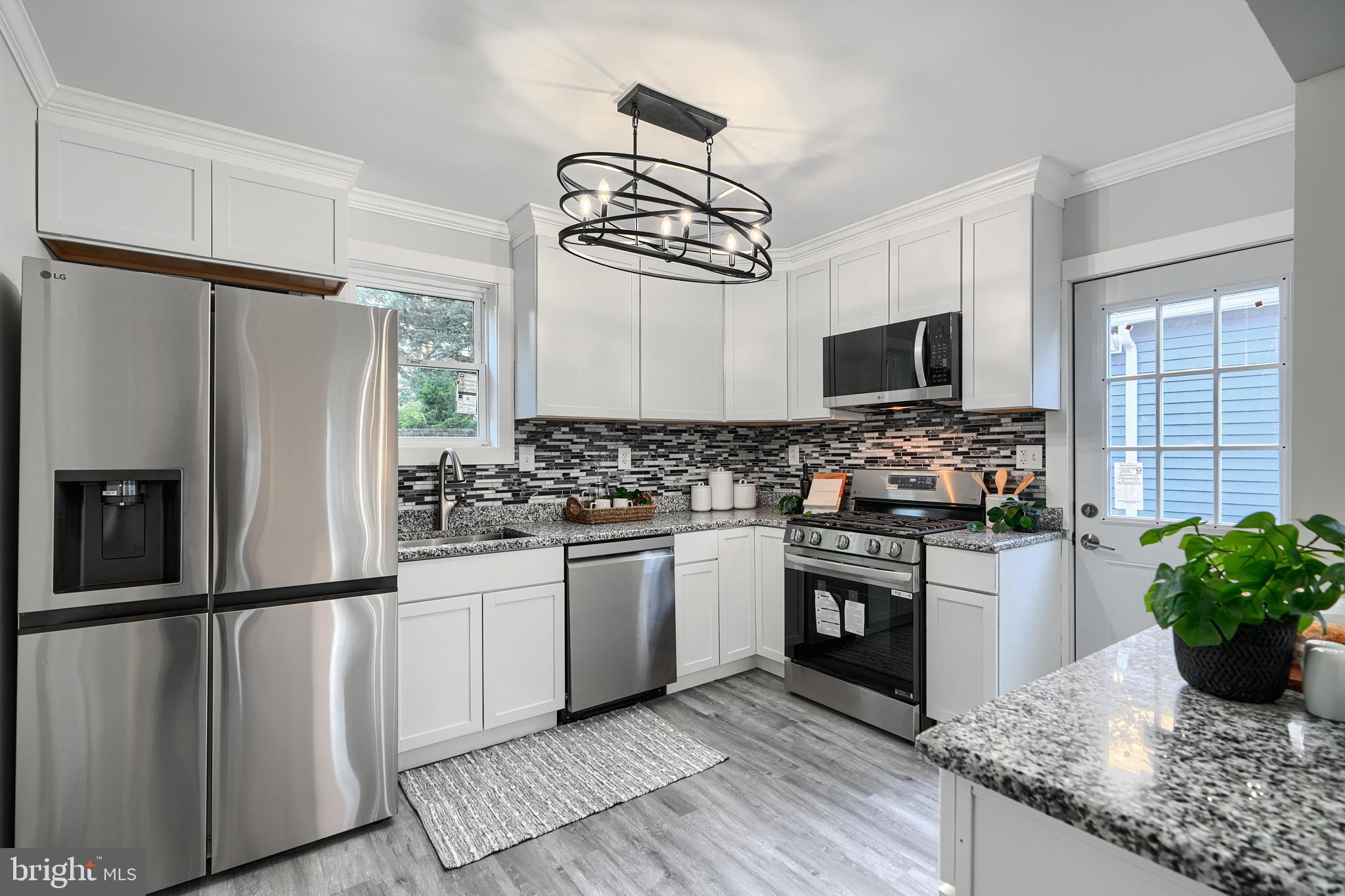 2919 Onyx Road Baltimore, MD 21234 - Photo 15 of 41 a kitchen with granite countertop a refrigerator stove and sink