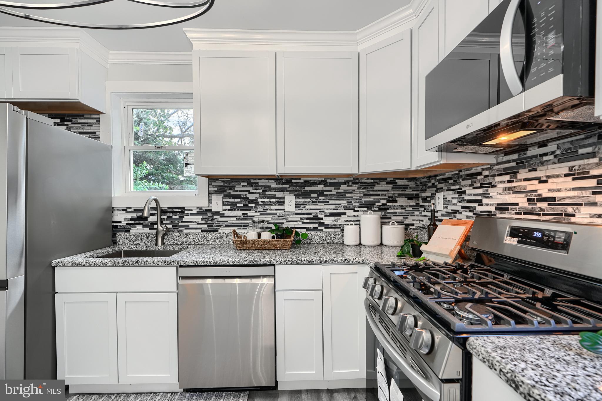 2919 Onyx Road Baltimore, MD 21234 - Photo 17 of 41 a kitchen with a stove a sink and a refrigerator