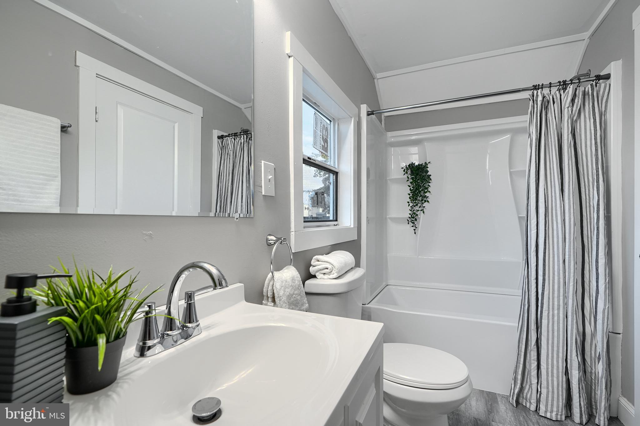 2919 Onyx Road Baltimore, MD 21234 - Photo 24 of 41 a bathroom with a granite countertop sink a toilet and shower