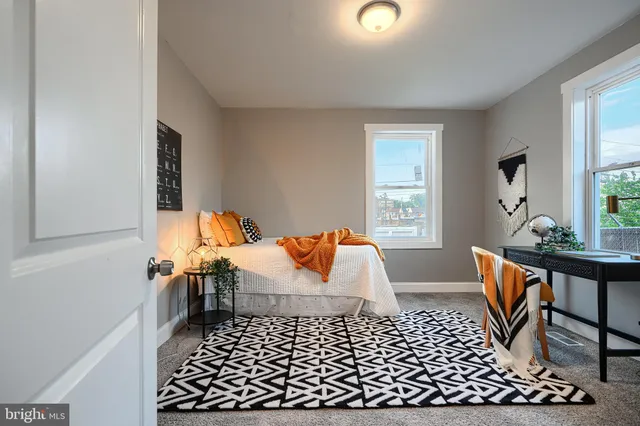 a living room with furniture rug and window