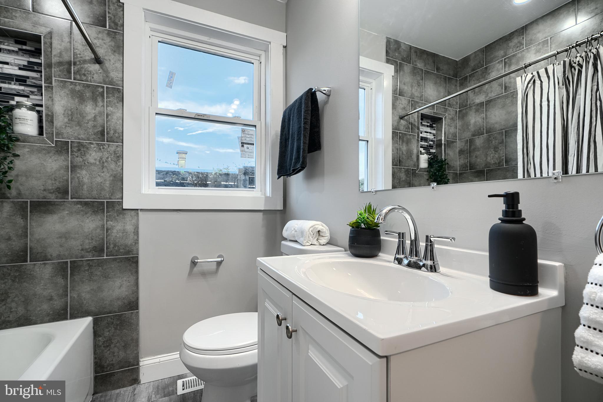 2919 Onyx Road Baltimore, MD 21234 - Photo 32 of 41 a bathroom with a toilet sink and mirror