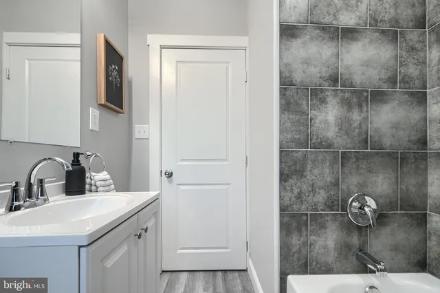 a bathroom with a sink and mirror