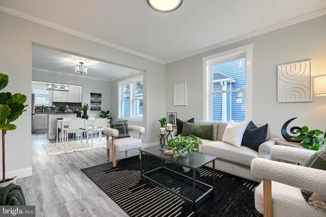 a living room with furniture or couch and a kitchen