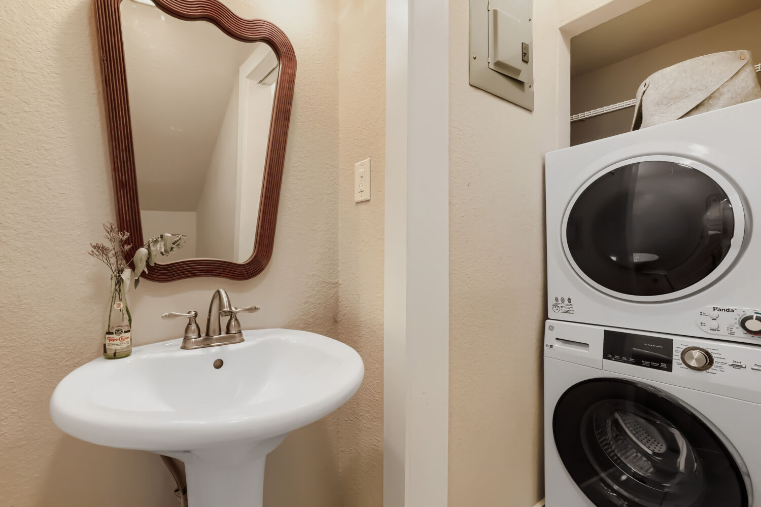 6211 Manor Road, Unit 105 Austin, TX 78723 - Photo 10 of 18 A convenient laundry area combines with a simple pedestal sink, maximizing utility in a compact space.