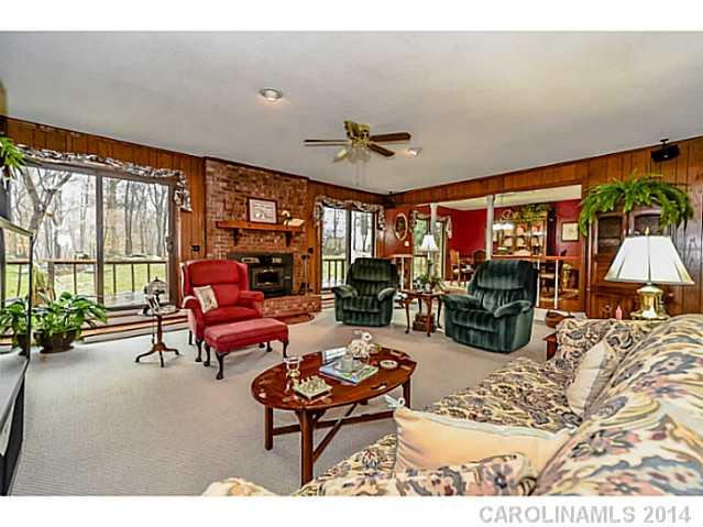 1611 Little Rock Road Charlotte, NC 28214 - Photo 4 of 16 a living room with furniture a chandelier and a large window