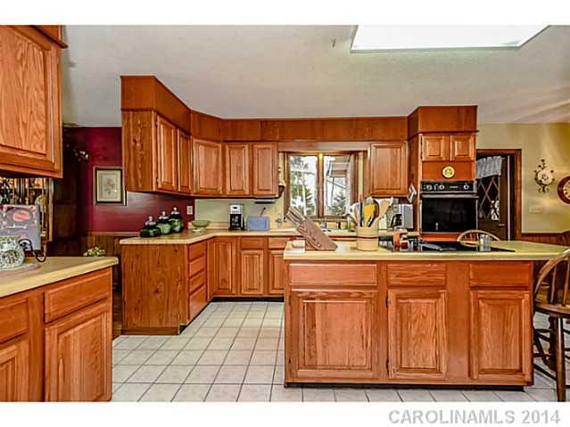 1611 Little Rock Road Charlotte, NC 28214 - Photo 7 of 16 a kitchen with stainless steel appliances granite countertop a stove a sink dishwasher and cabinets with wooden floor