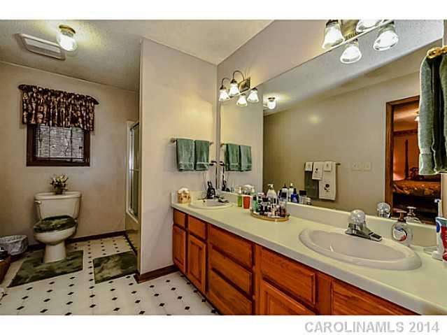 1611 Little Rock Road Charlotte, NC 28214 - Photo 9 of 16 a bathroom with a double vanity sink and a mirror