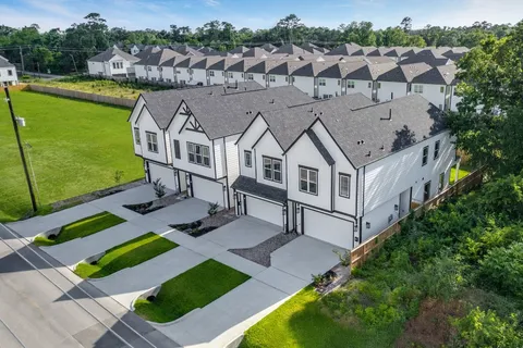 an aerial view of a house with a big yard