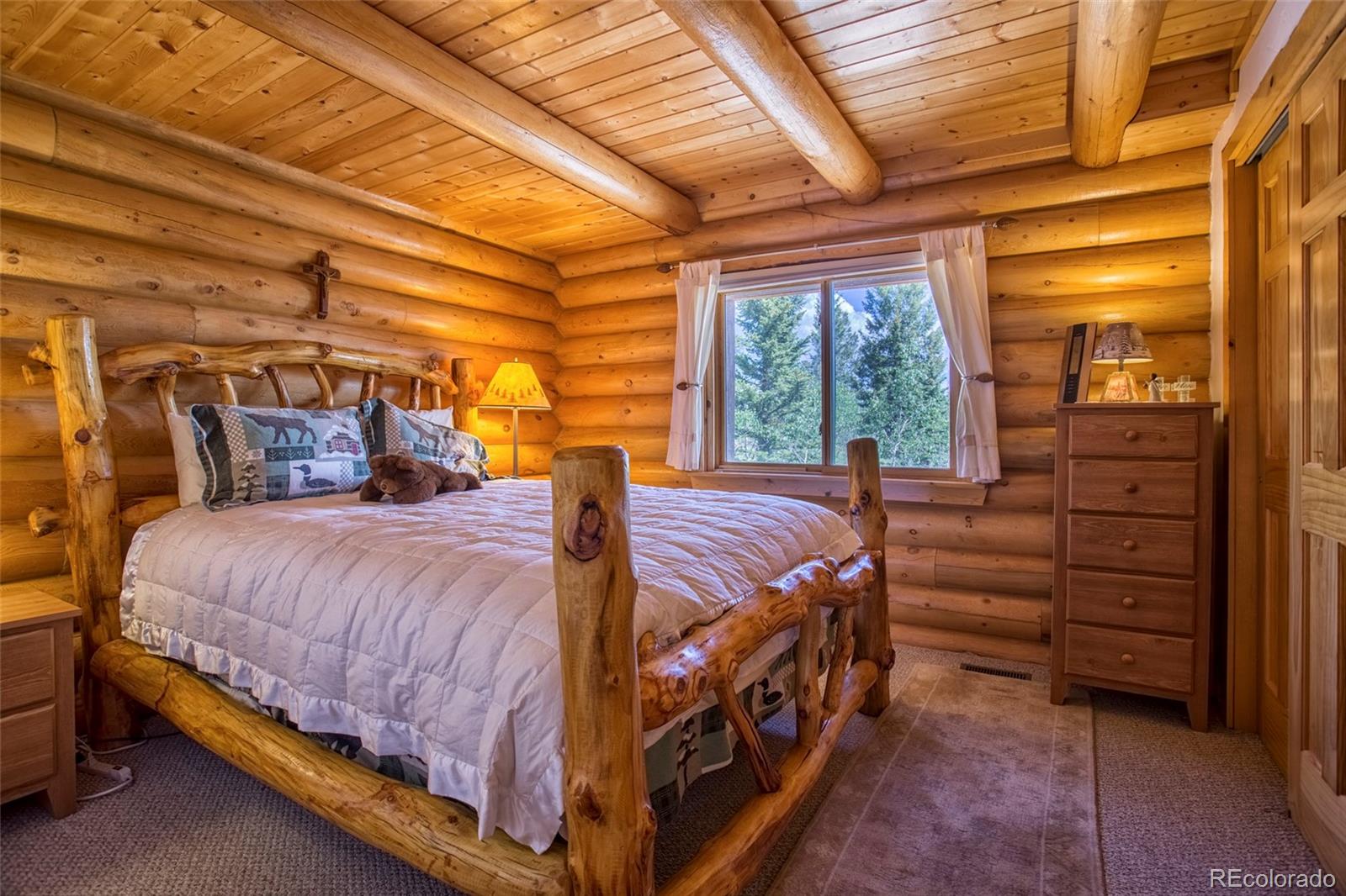 144 Red Cloud Road Como, CO 80456 - Photo 16 of 34 a bed sitting in a bedroom next to a window