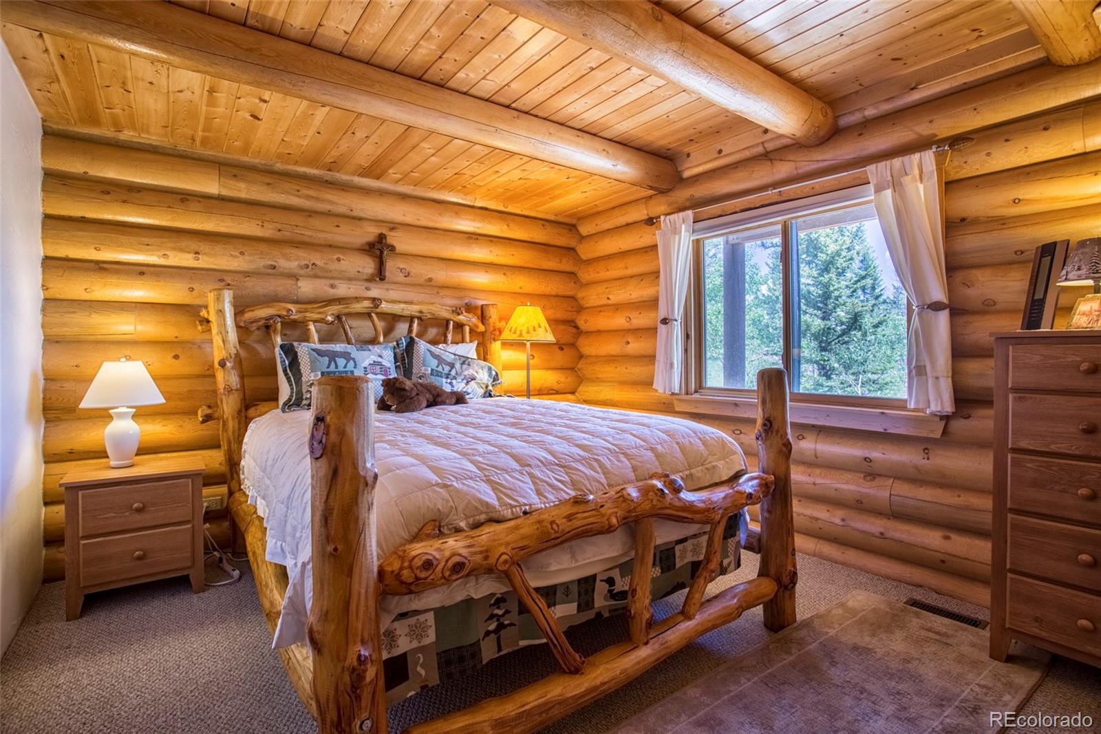 144 Red Cloud Road Como, CO 80456 - Photo 17 of 34 a bed sitting in a bedroom next to a window